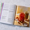Cold Canning book open to page that displays recipes on the left and food photographs on the right