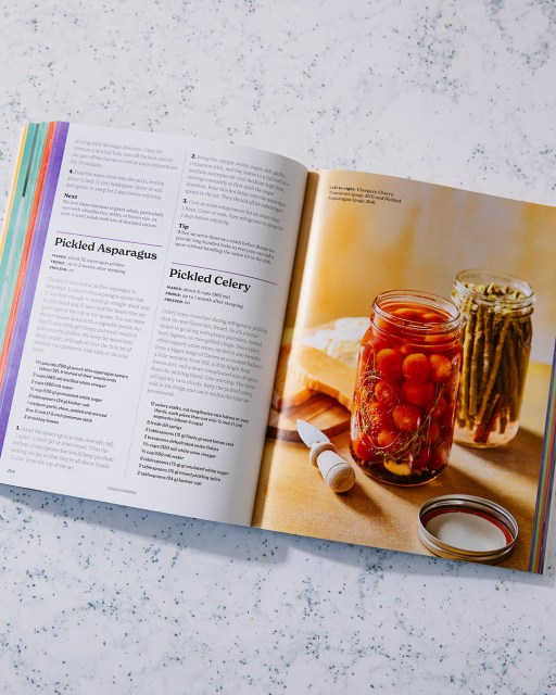 Cold Canning book open to page that displays recipes on the left and food photographs on the right